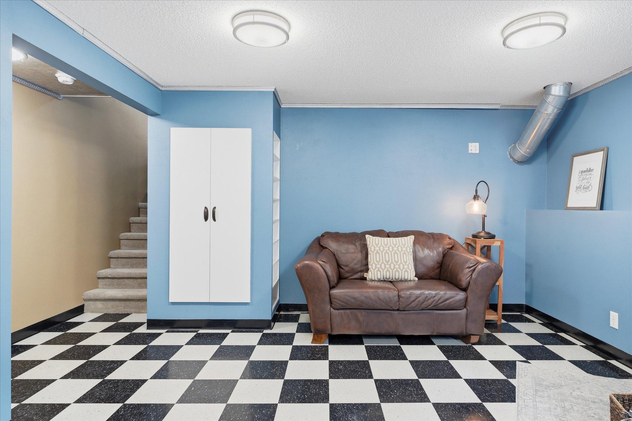 Wow - what a cool space. The checkered flooring just screams "fun!" The built-in shelves and cabinets are such efficient uses of space.