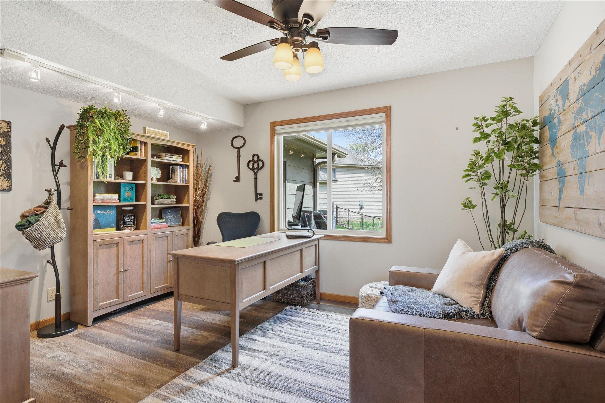 This room could eaily be used as a main level bedroom, but it's currently being used as a home office. The flooring and ceiling fan are stunning details.
