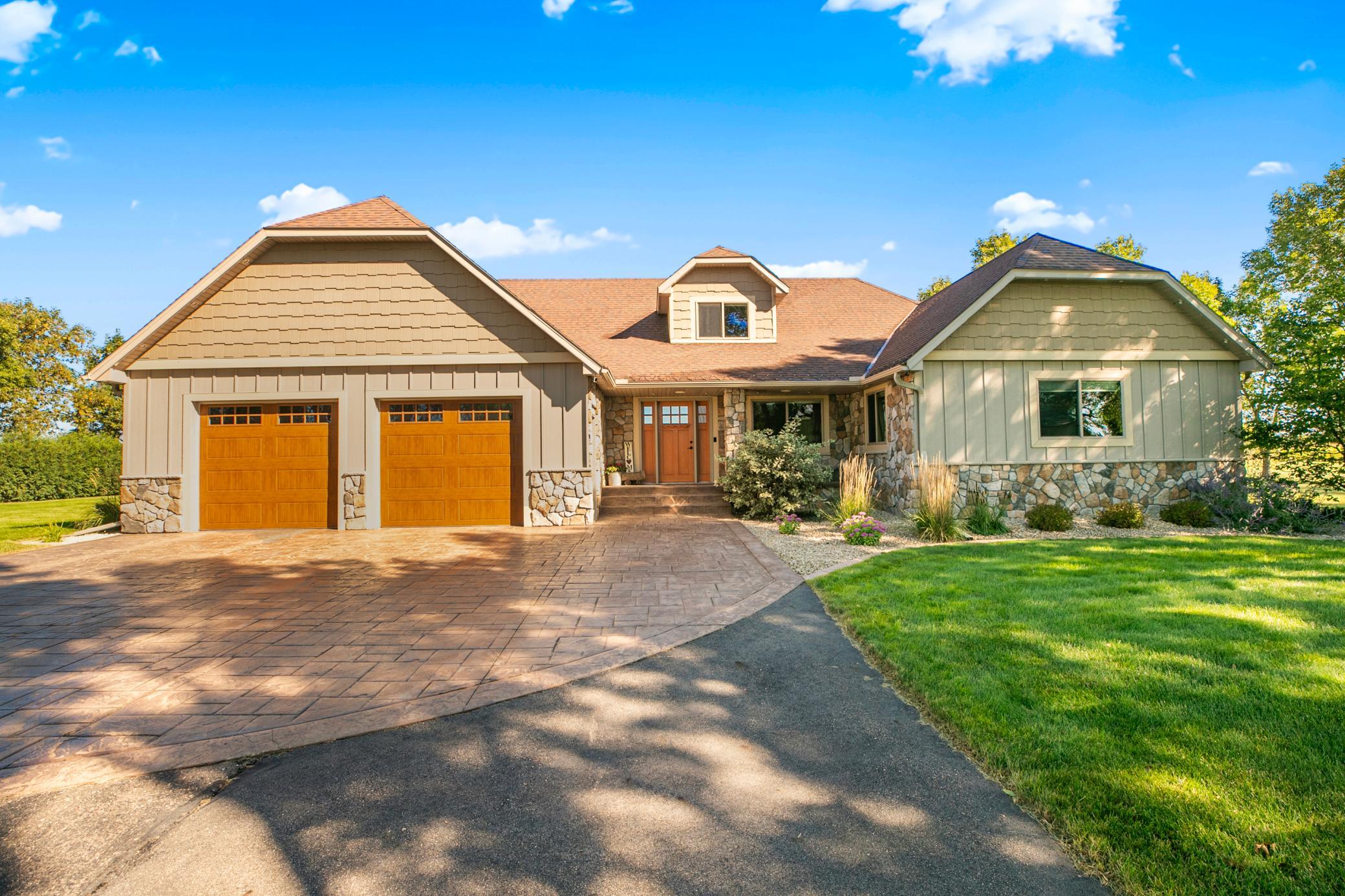 The home’s exterior was completely redone in 2016, showcasing LP SmartSide siding, shake accents, stonework, and stamped-colored concrete.