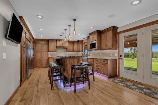 Undercabinet lighting and tiled backsplash add warmth and function.