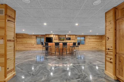 The lower level is built for fun and flexibility, featuring a knotty pine game room, full wet bar, and ample space for gatherings.