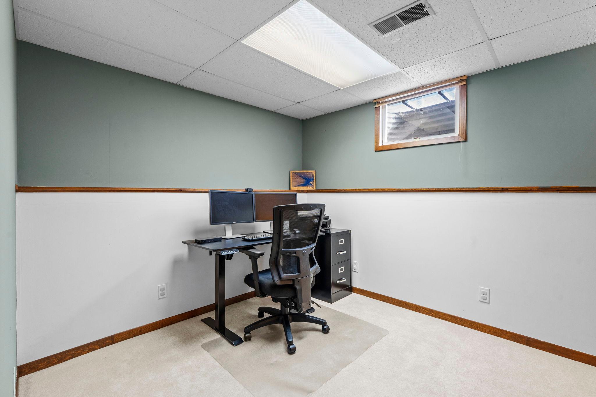 Finished lower-level office/den offers a private space set up for working from home, a study area, or a cozy retreat. Versatile flex room easily adapts to your needs—home office, guest space, hobby room, etc.