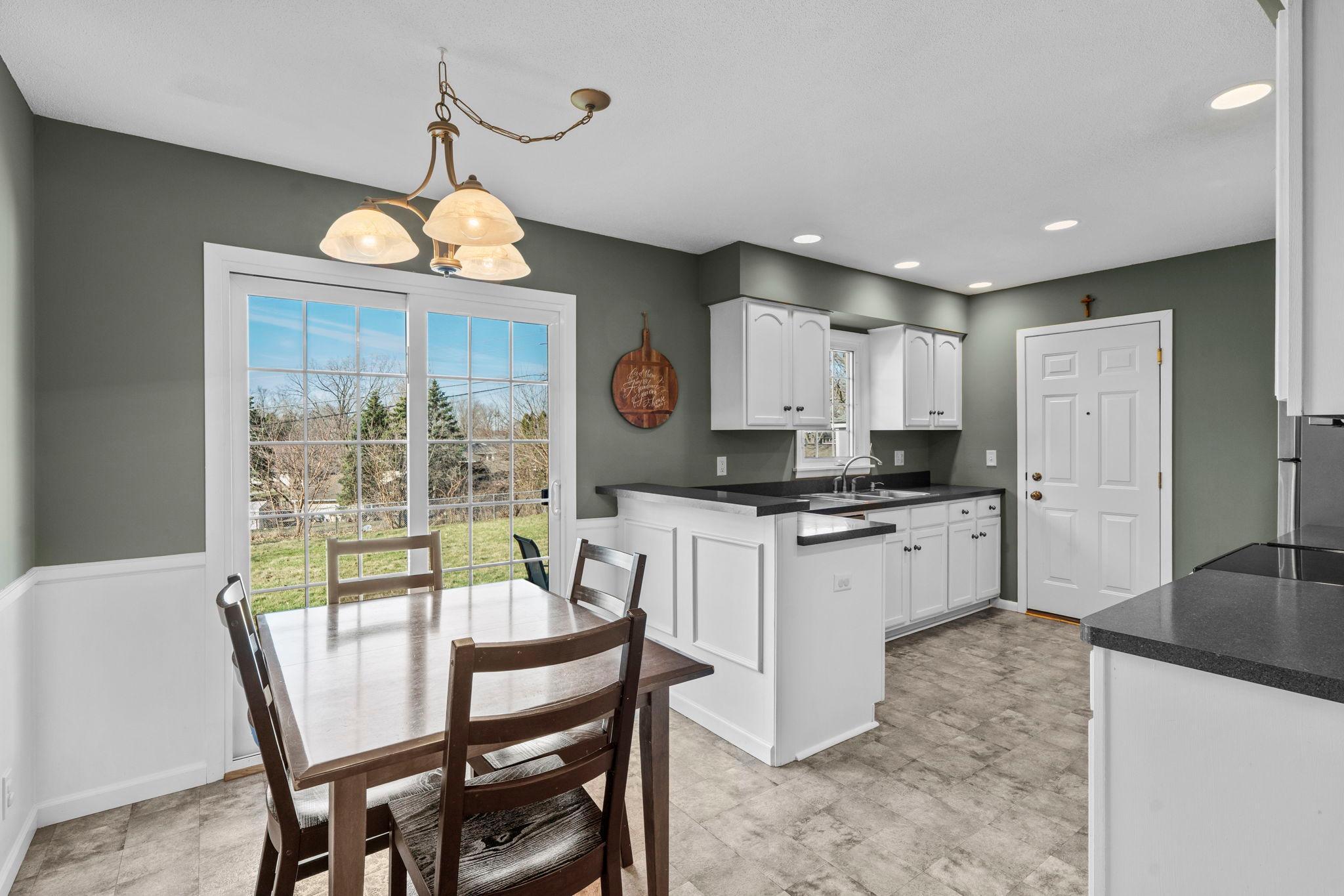 Such a lovely kitchen with modern white cabinetry, stylish countertops and Stainless Steel appliances.