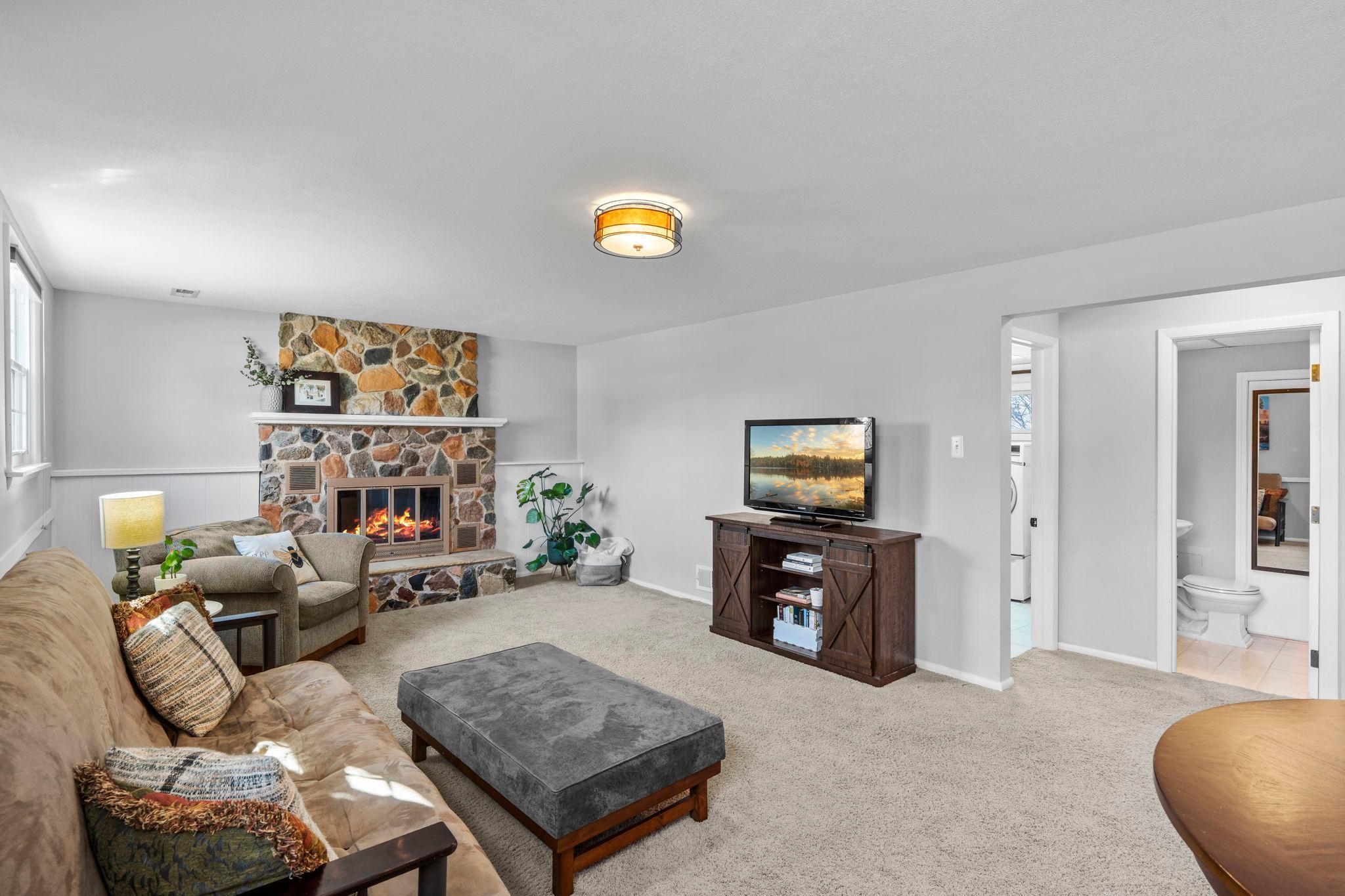 Cozy, basement retreat! Highlighted by stone, wood-burning fireplace!