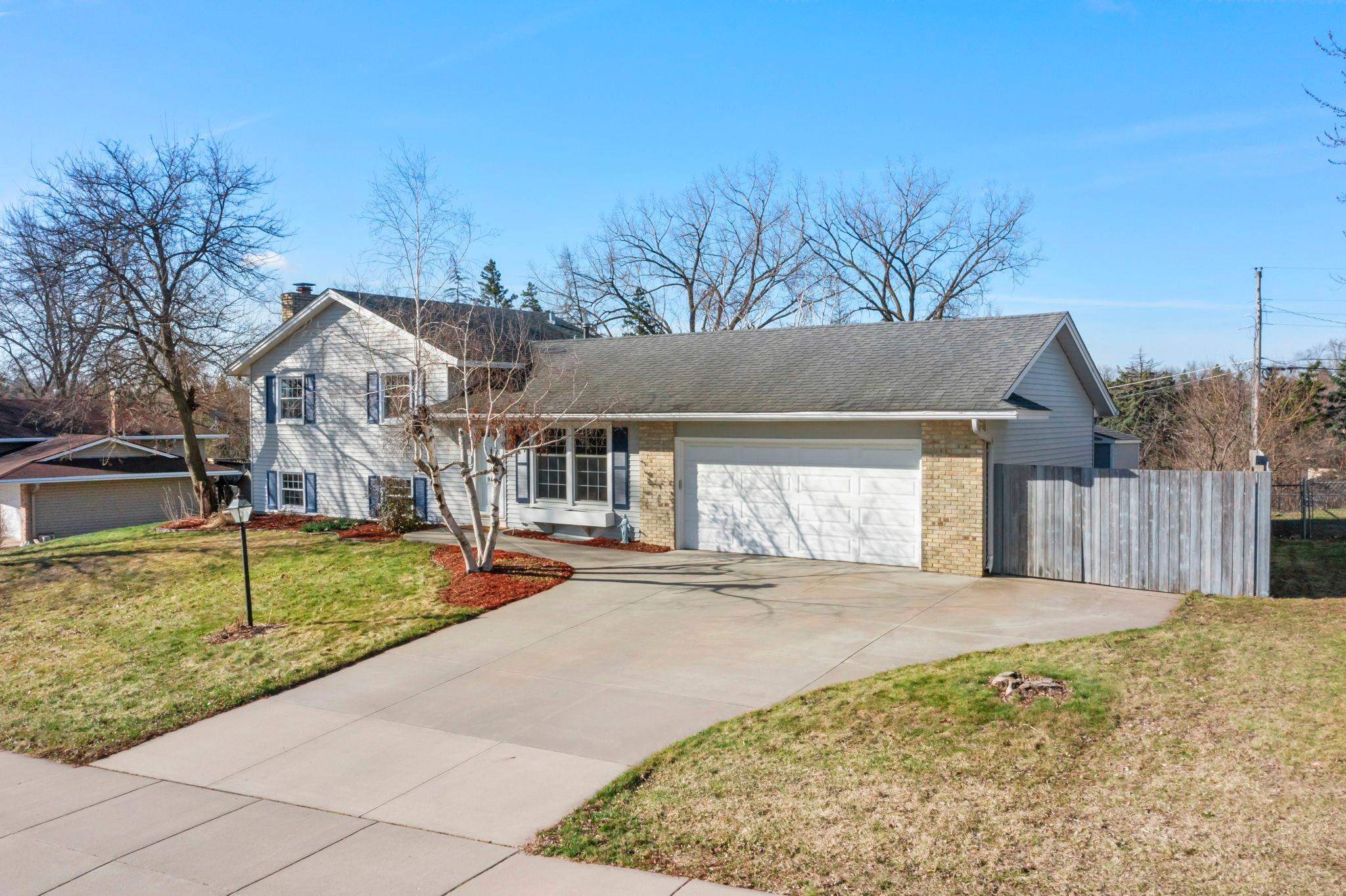 Upgraded concrete driveway with extra fenced in parking pad for fun things - boat, trailers, recreational vehicles and more!