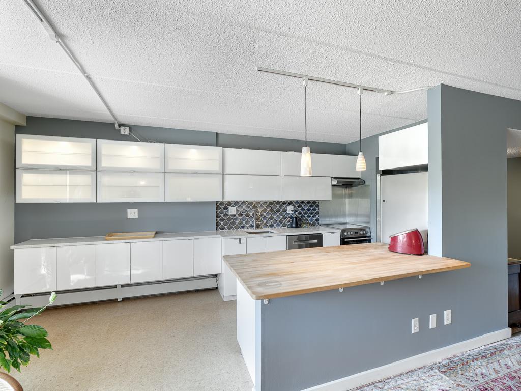 Look at all those cabinets and that great butcher block island workspace.