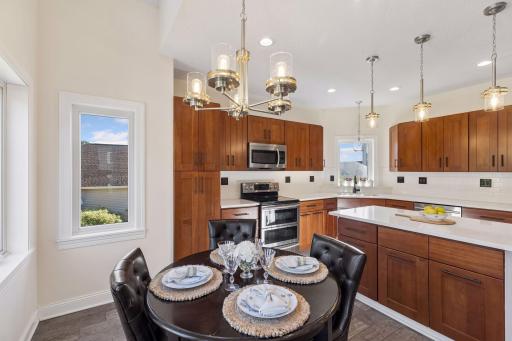 Open kitchen with center island, brand new countertops and backsplash.