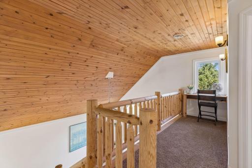 Cedar-lined vaulted ceiling, balcony overlooking the main living area.