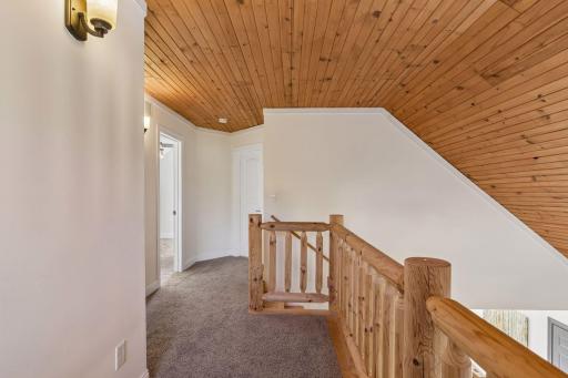 Cedar-lined vaulted ceiling, balcony overlooking the main living area.