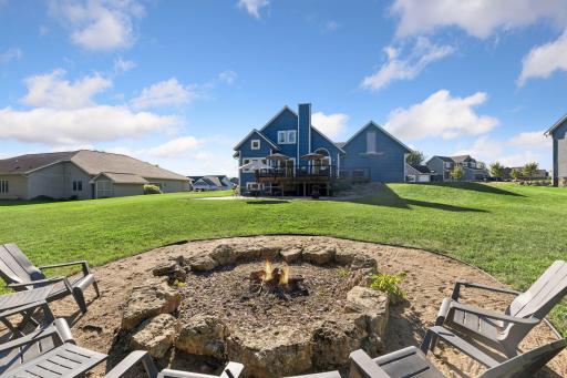 Oversized backyard with firepit, bordering the woods for added privacy.