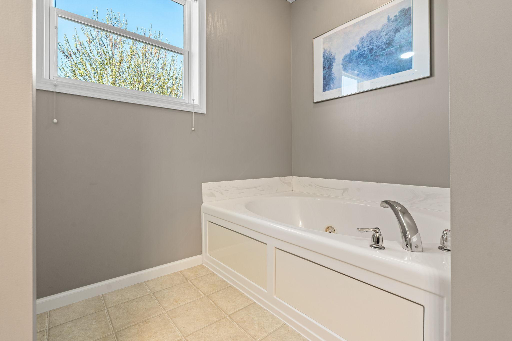 Large soaking tub in the primary bathroom