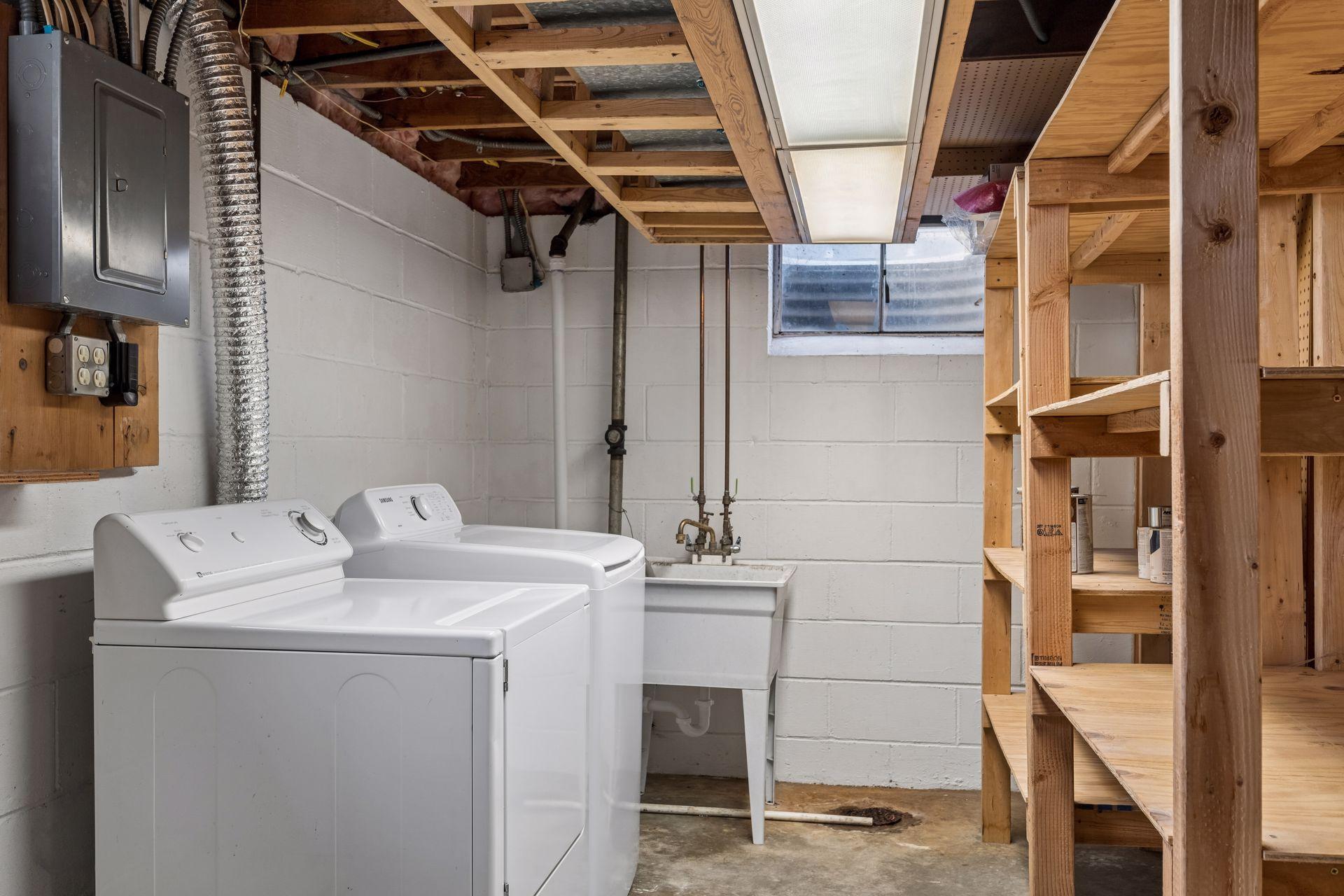 Laundry and generous shelf storage in basement.