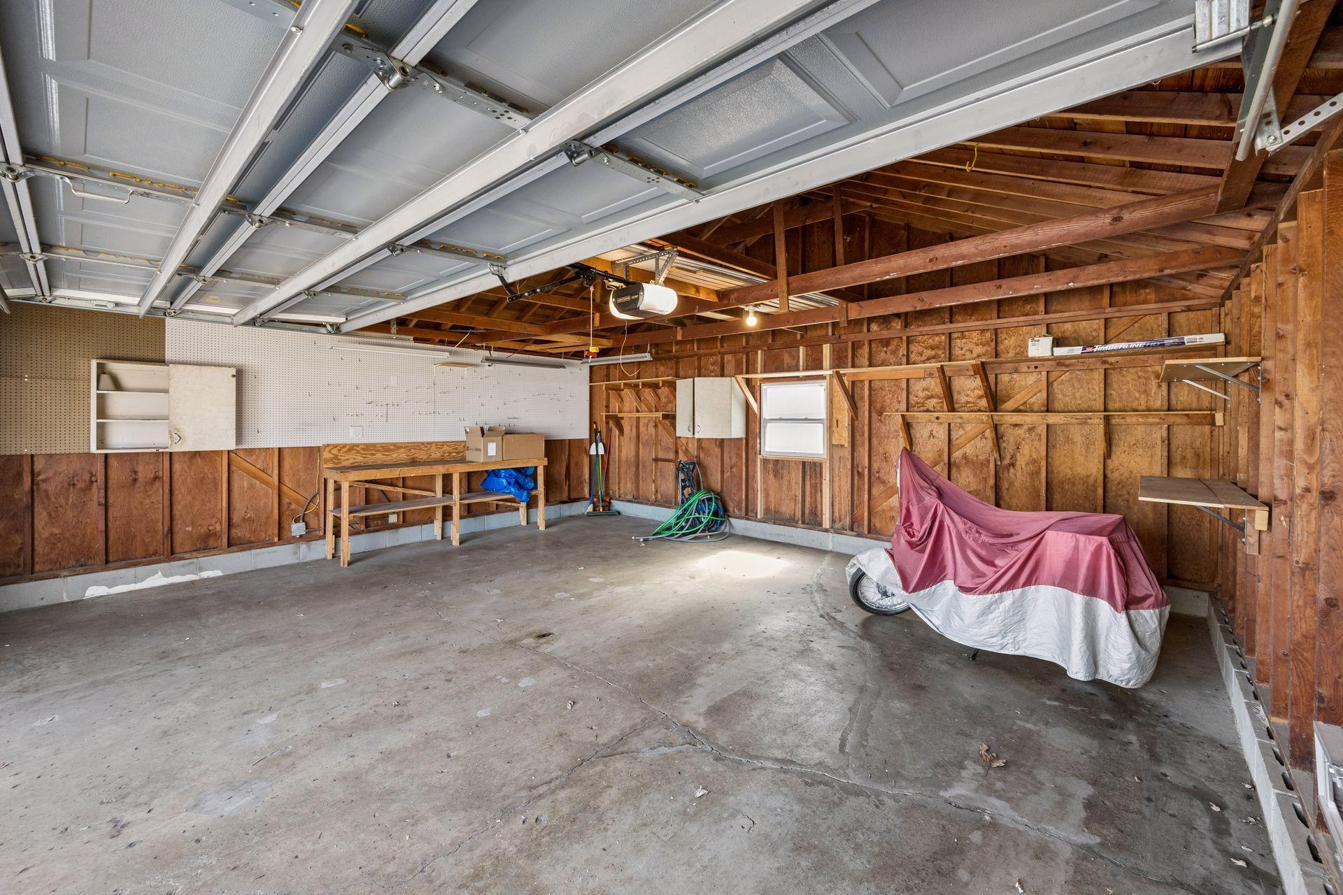 This spacious garage offers plenty of space for your vehicles, and workspace!