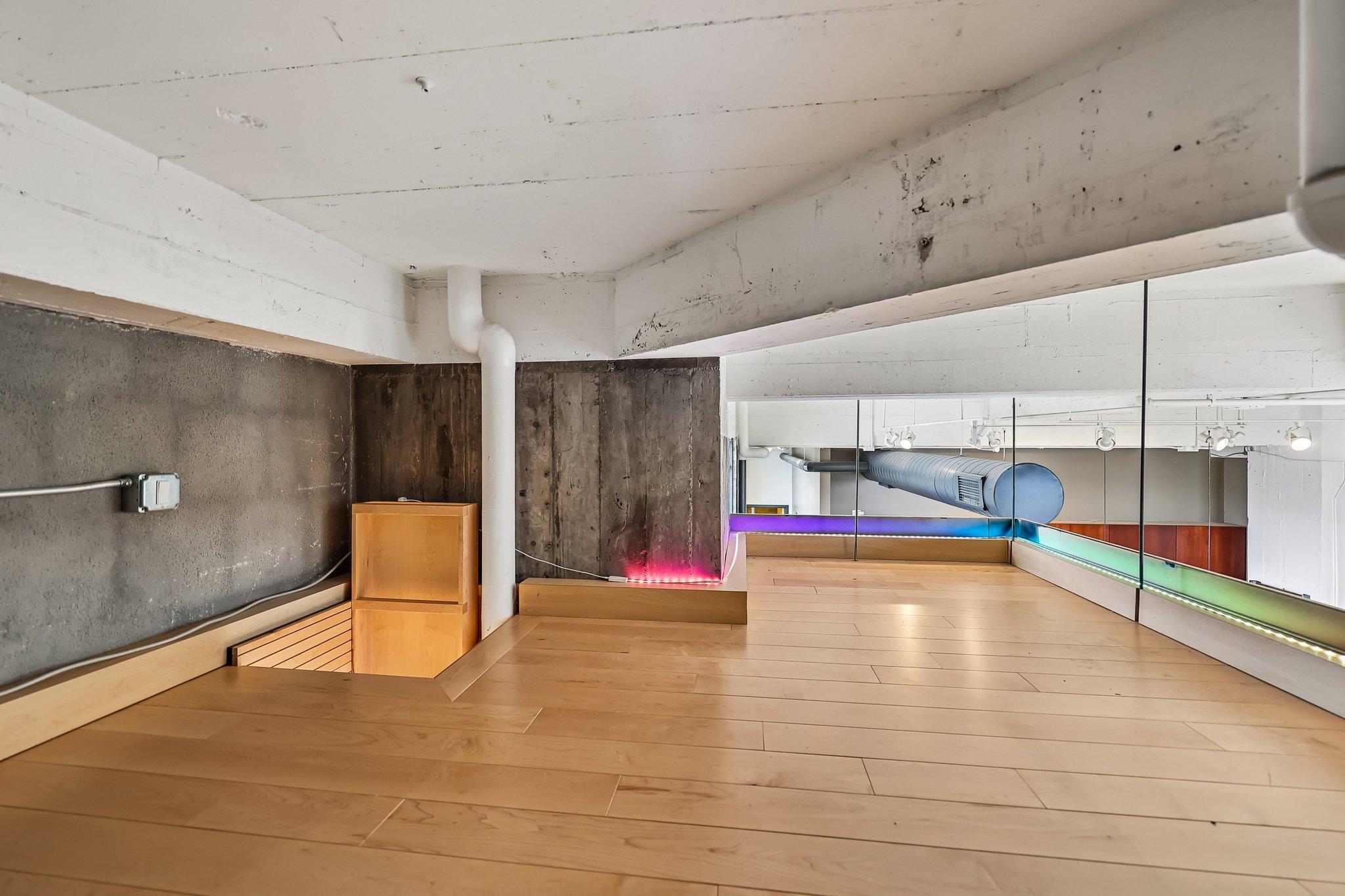 Loft area accessible by built-in ladder through office alcove.