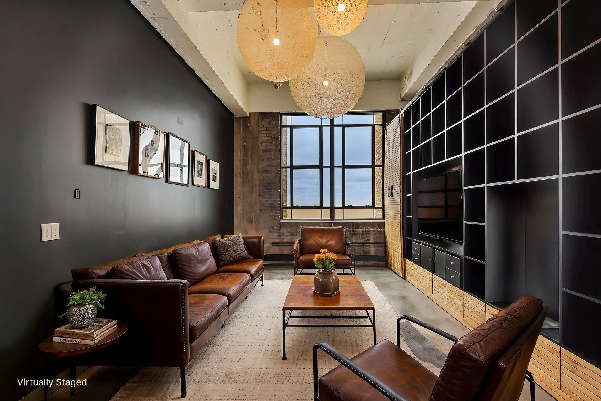 Custom built living room/entertainment/library space and designer lighting. True loft architecture with 13-ft celings, exposed brick and concrete floors.