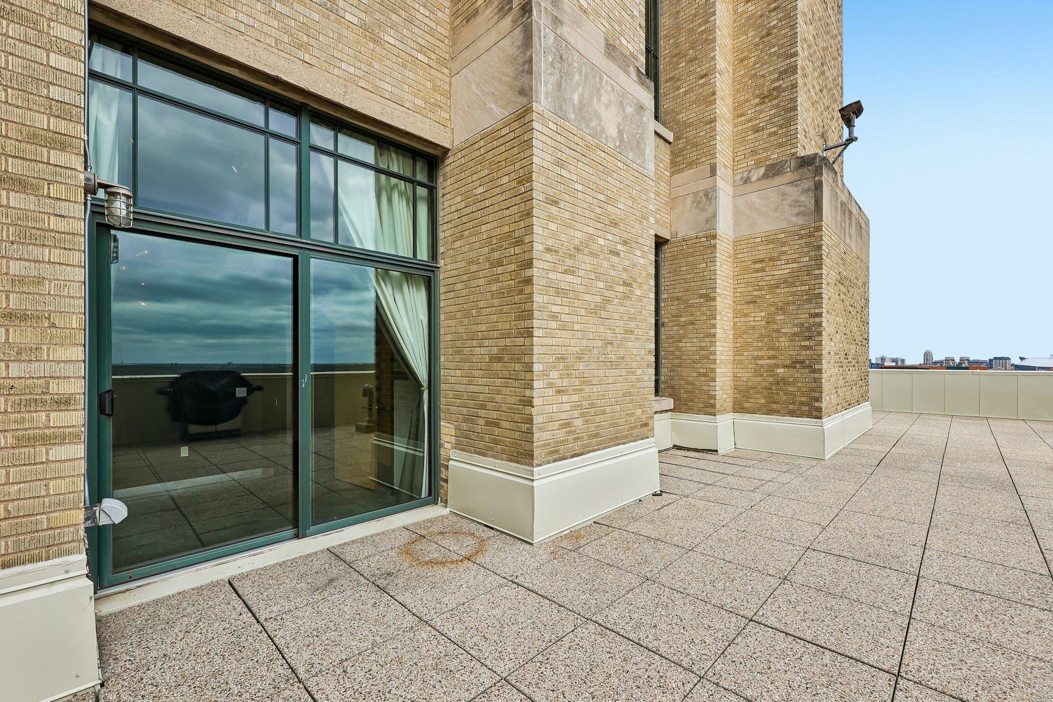 This historic unit is home to the LARGEST private rooftop terrace in all of Minneapolis, with City skyline views spanning three lengths of the entire condo.