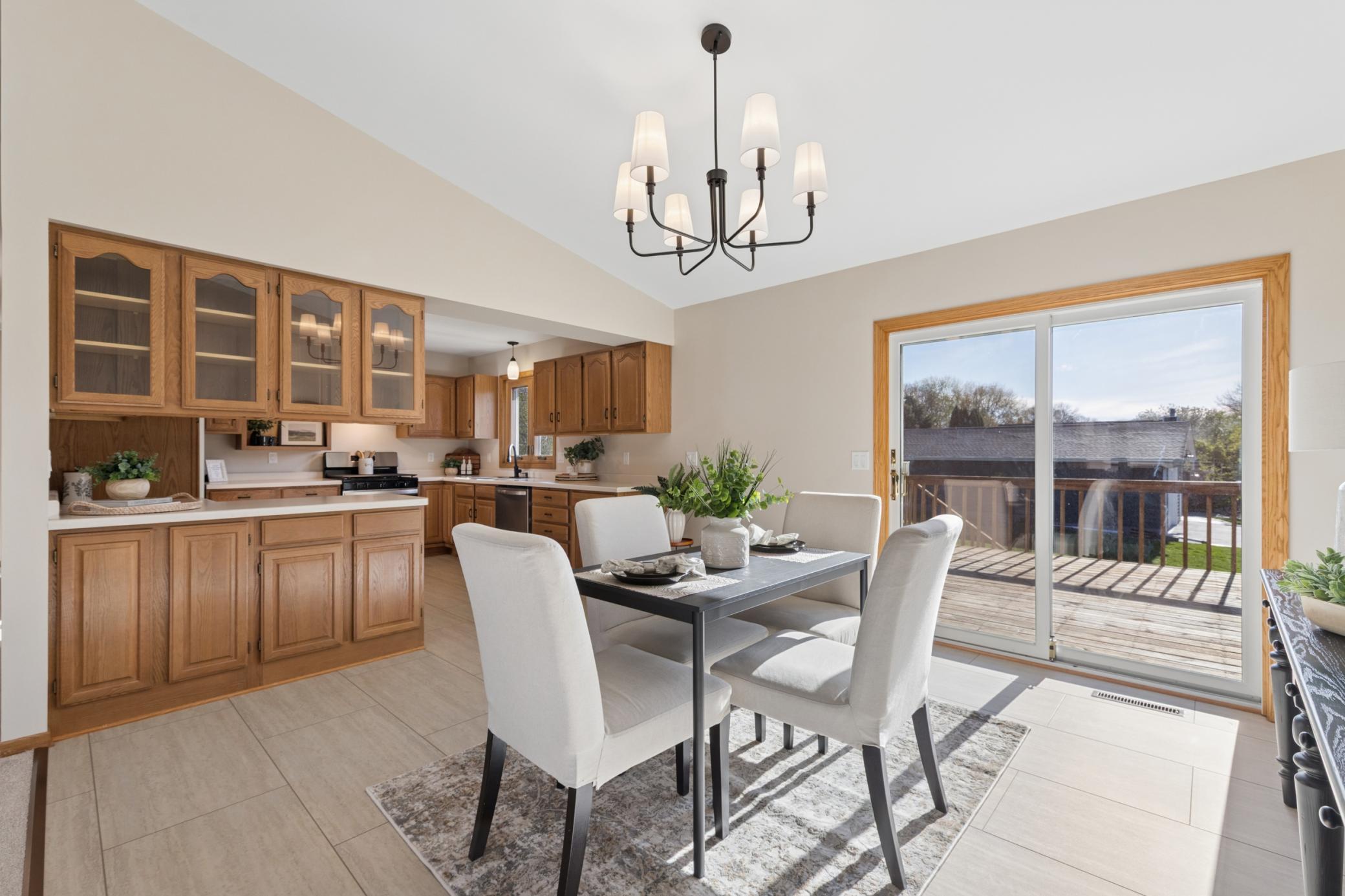 Open-concept flow between the dining and kitchen areas, refreshed with new LVT flooring and neutral paint—an ideal space for entertaining.