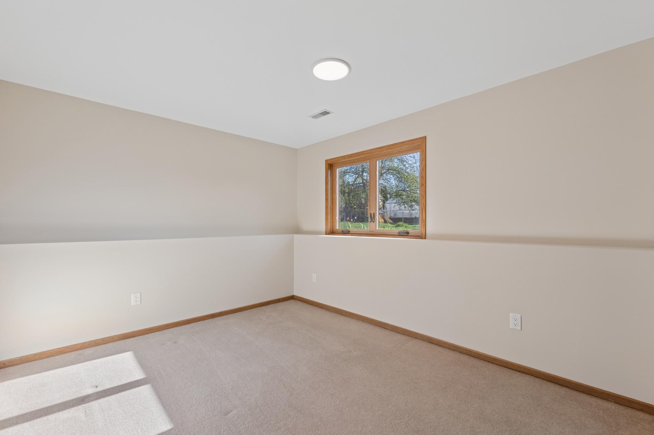 Comfortable third bedroom located on the lower level, ideal for family or overnight guests.