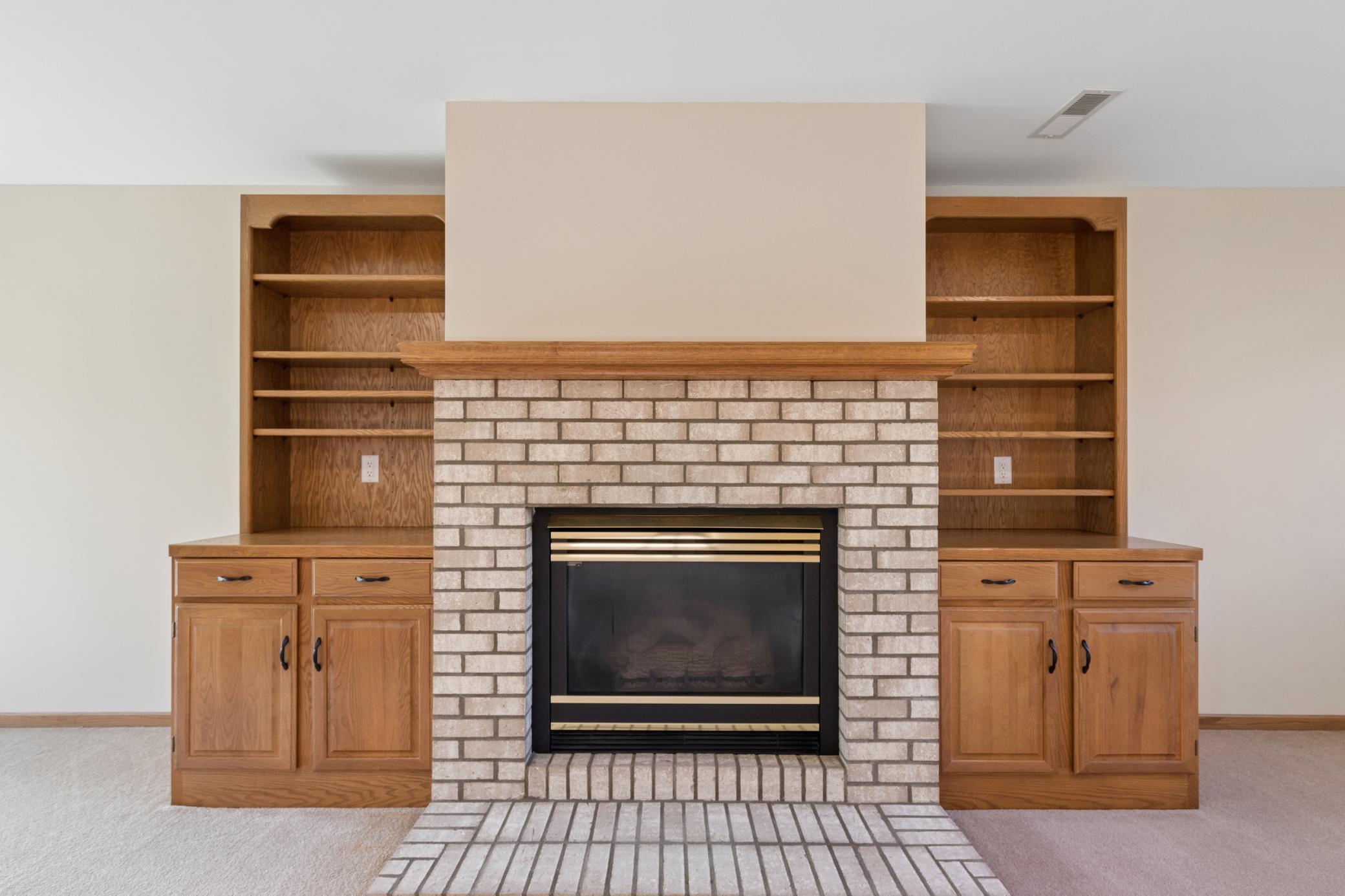 The focal point of the family room - inviting fireplace complemented by custom built-in shelving and cabinetry.