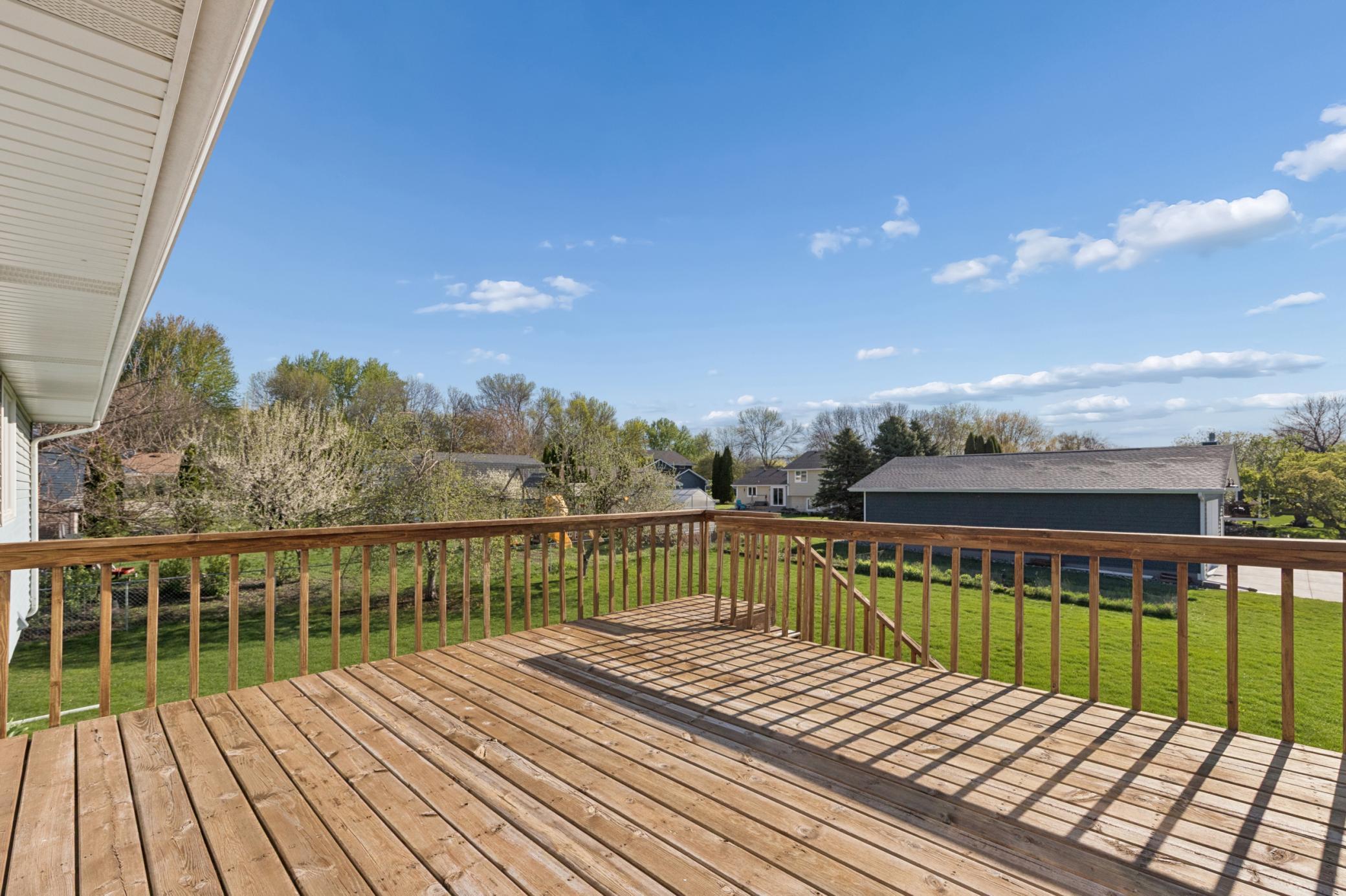 Enjoy seamless indoor/outdoor living with a large, inviting deck that overlooks the backyard and features a professionally installed newer retaining wall.