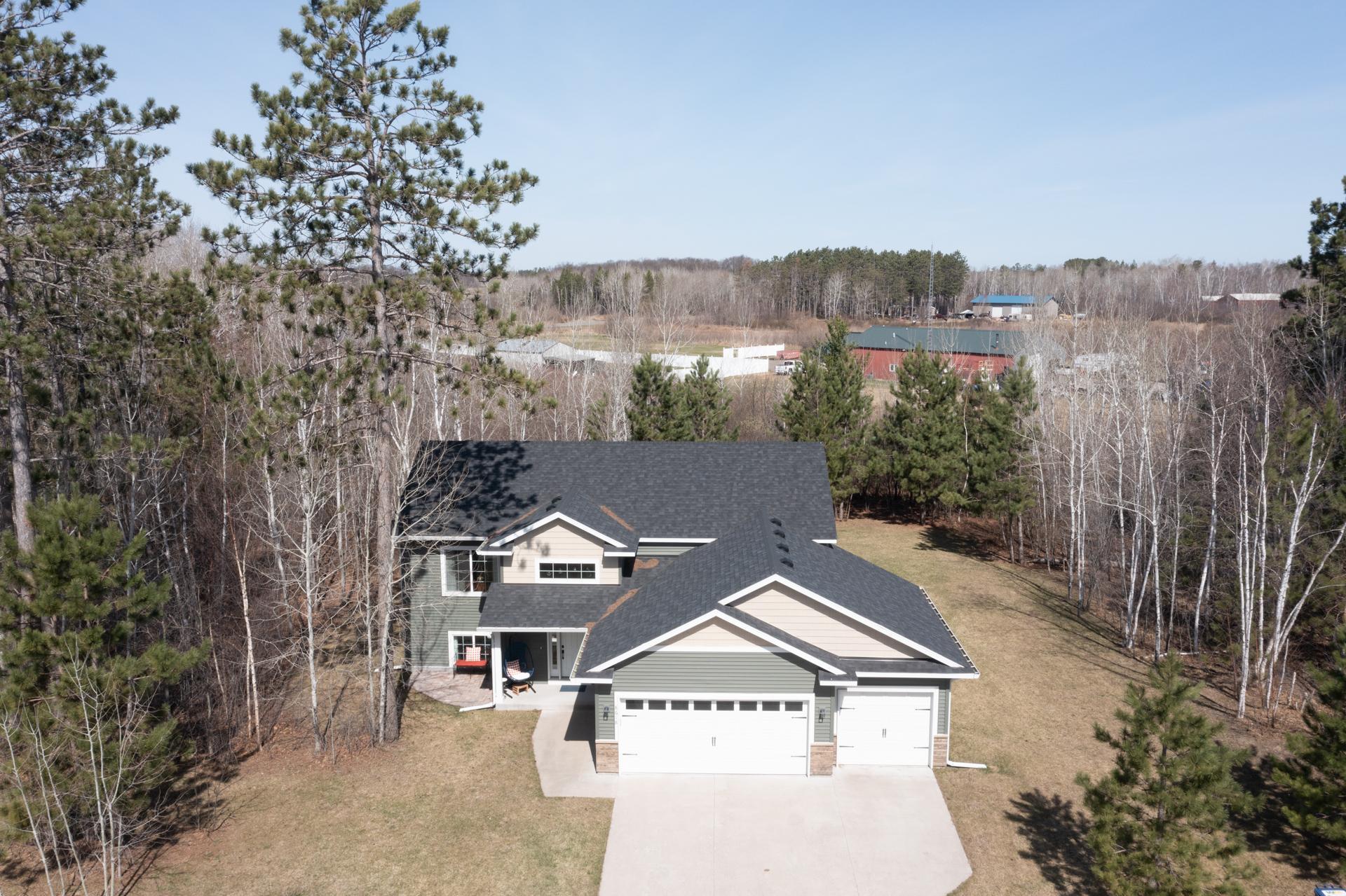 Beautiful aerial view showcasing private wooded setting.