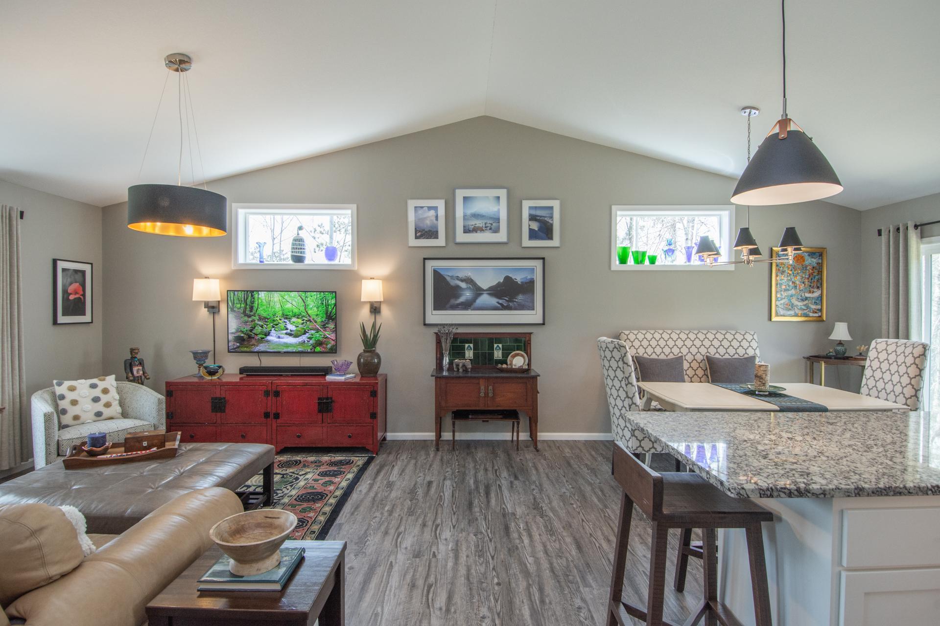 Warm and inviting living room filled with natural light, featuring large windows, updated flooring, and a comfortable layout that feels both open and cozy.