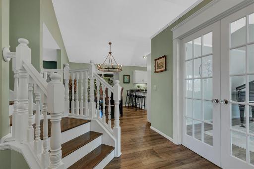Charming character the moment you walk in. Note the beautiful hardwood floors on the stair treads and the recently updated flooring throughout the main level