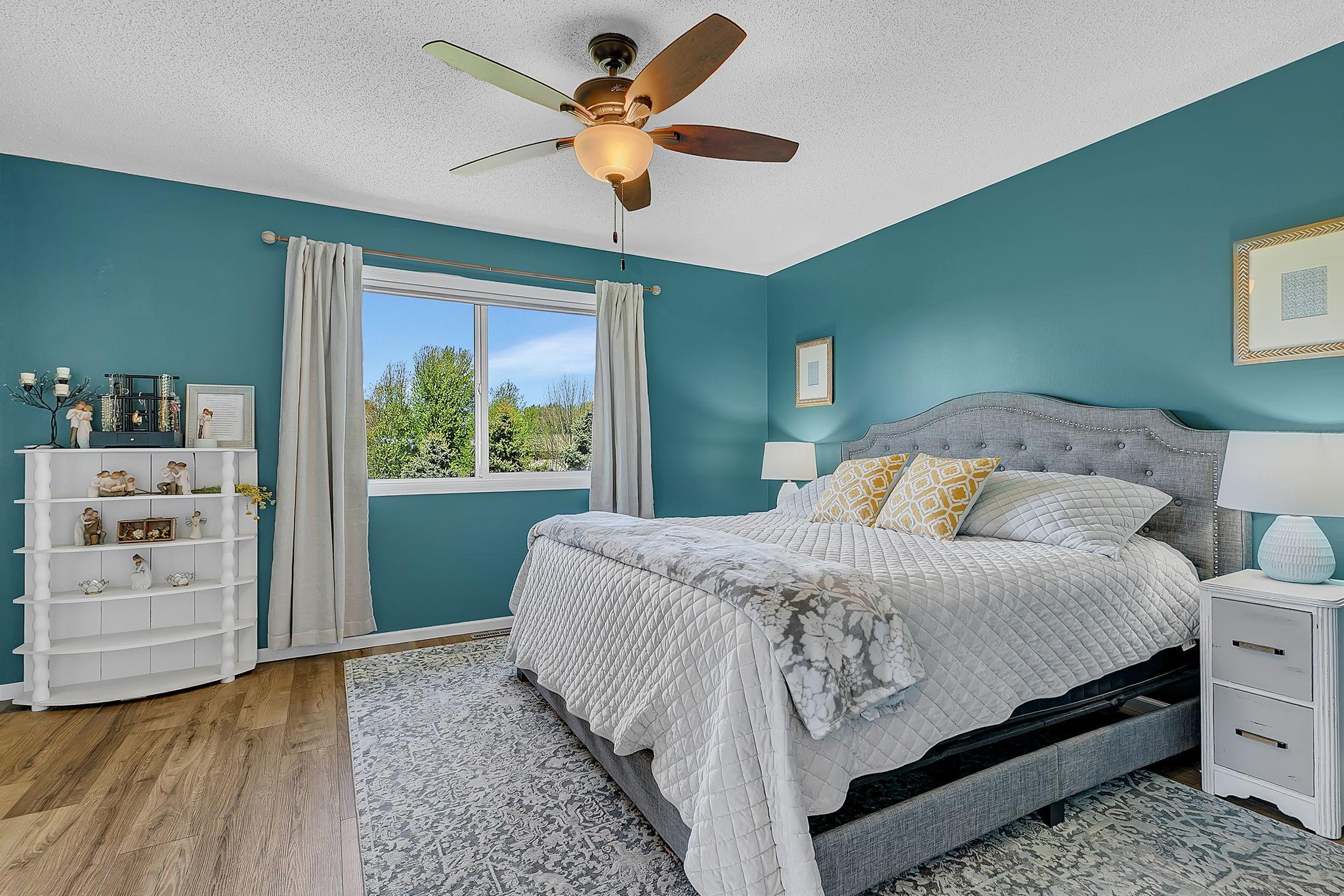 Primary suite with great views, natural light, walk in closet and walk-thru full bath