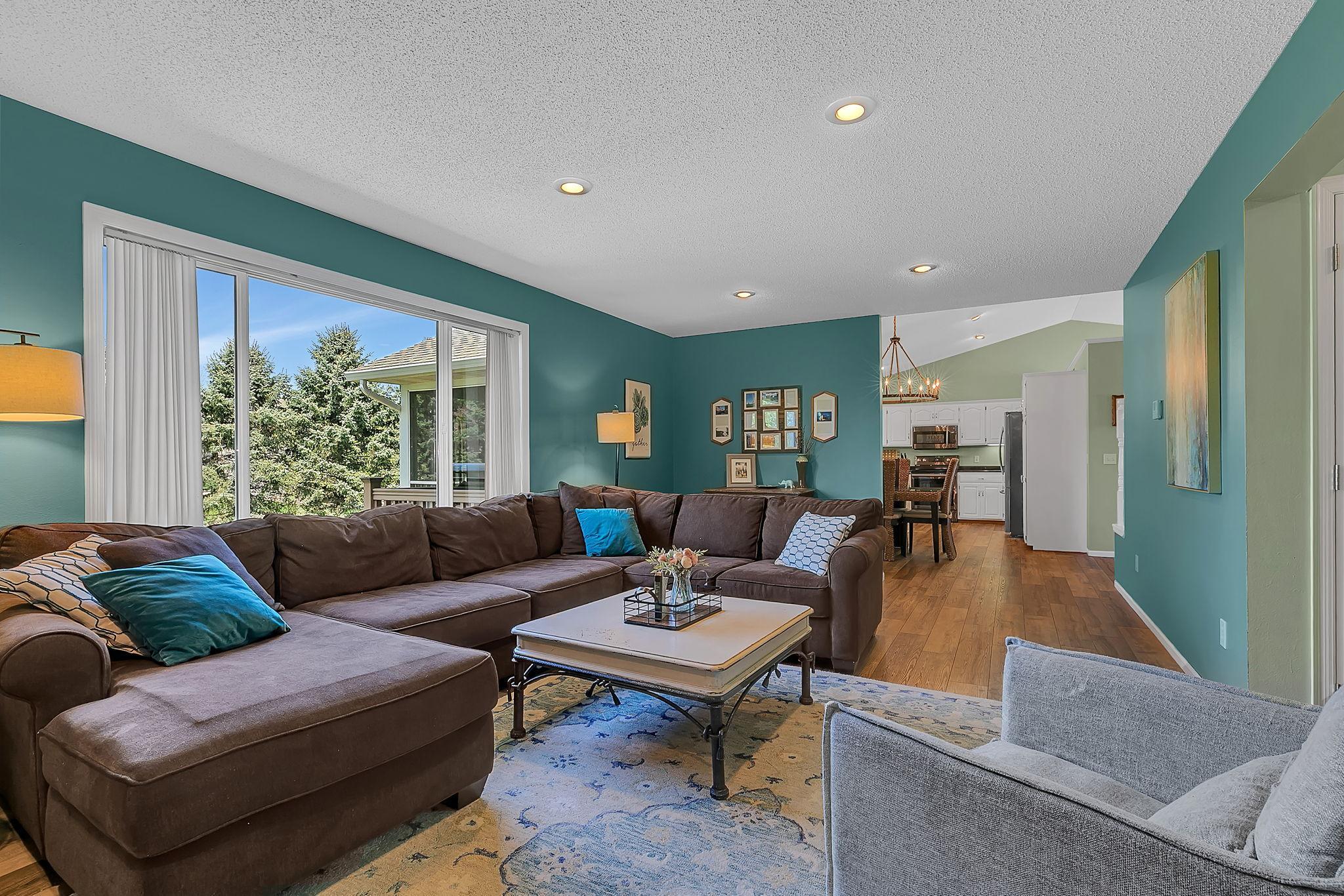 Main level living room has sightlines from the dining and kitchen