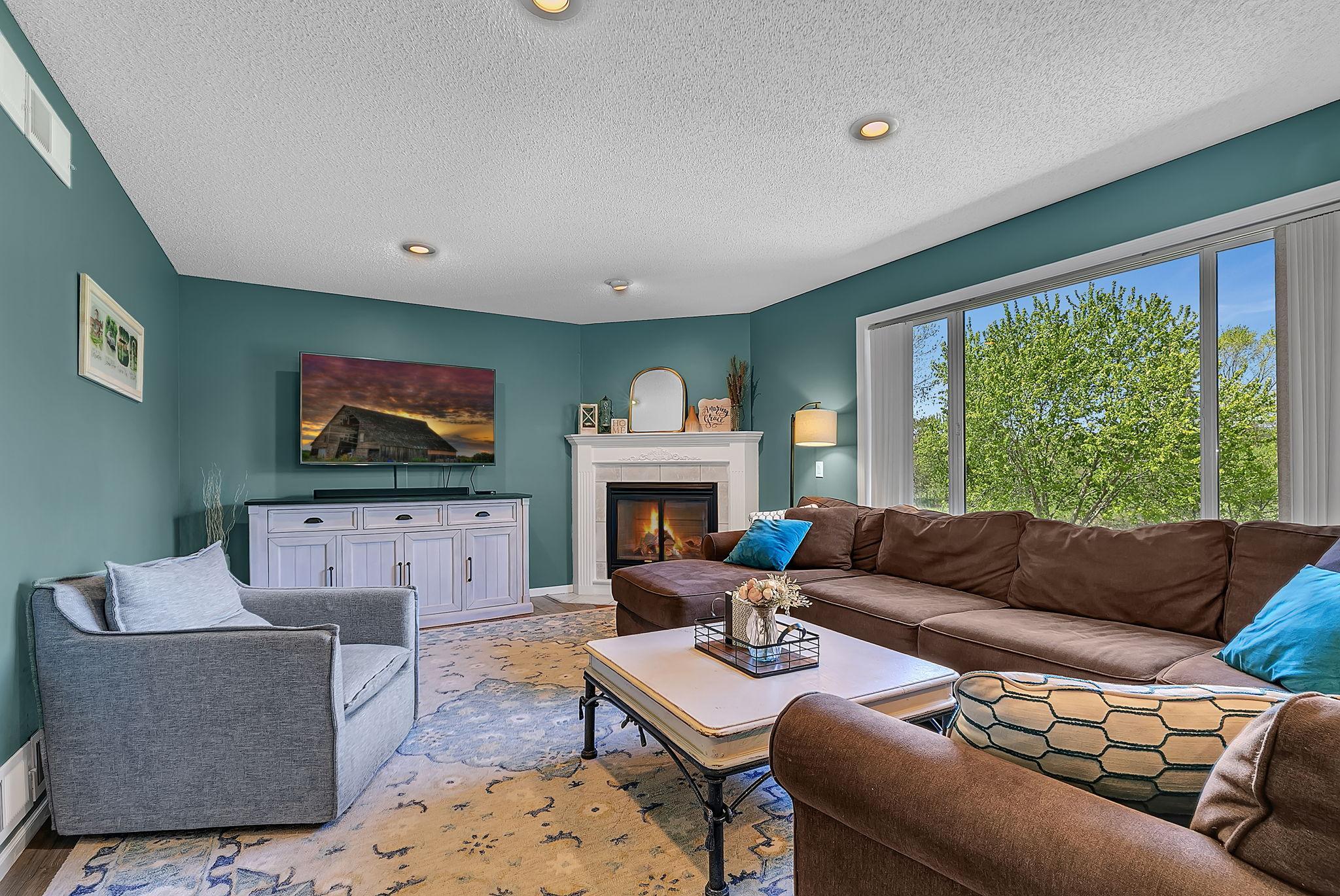 Large main level living room with gas fireplace + huge window for country views