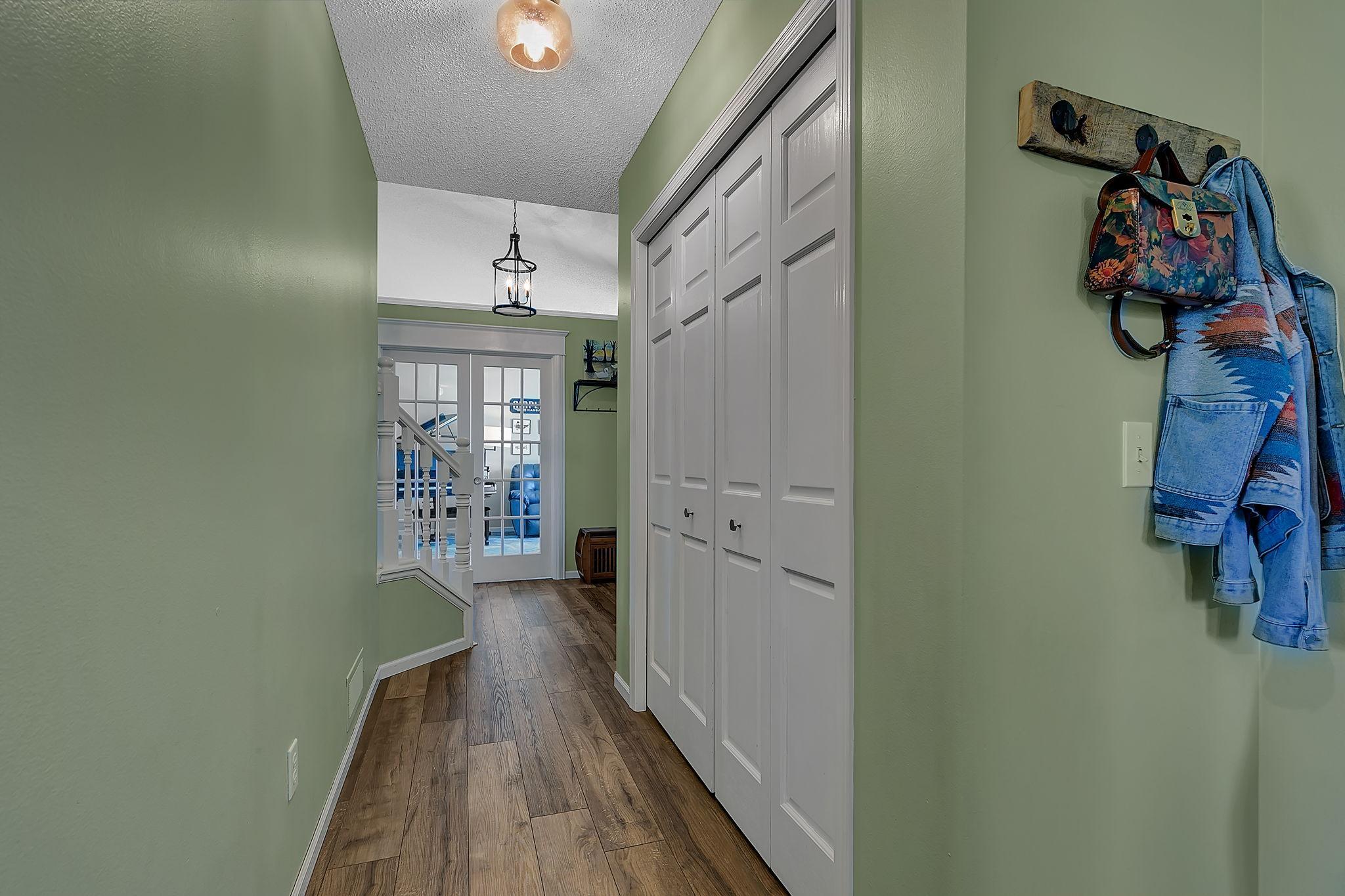 Hall from the entry to the main level half bath, garage access and laundry room