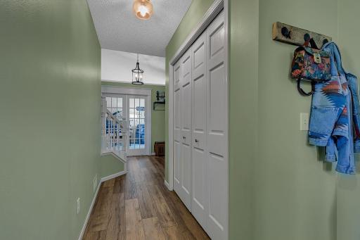 Hall from the entry to the main level half bath, garage access and laundry room