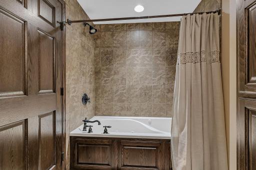 LL bath has a tiled surround and huge jetted tub