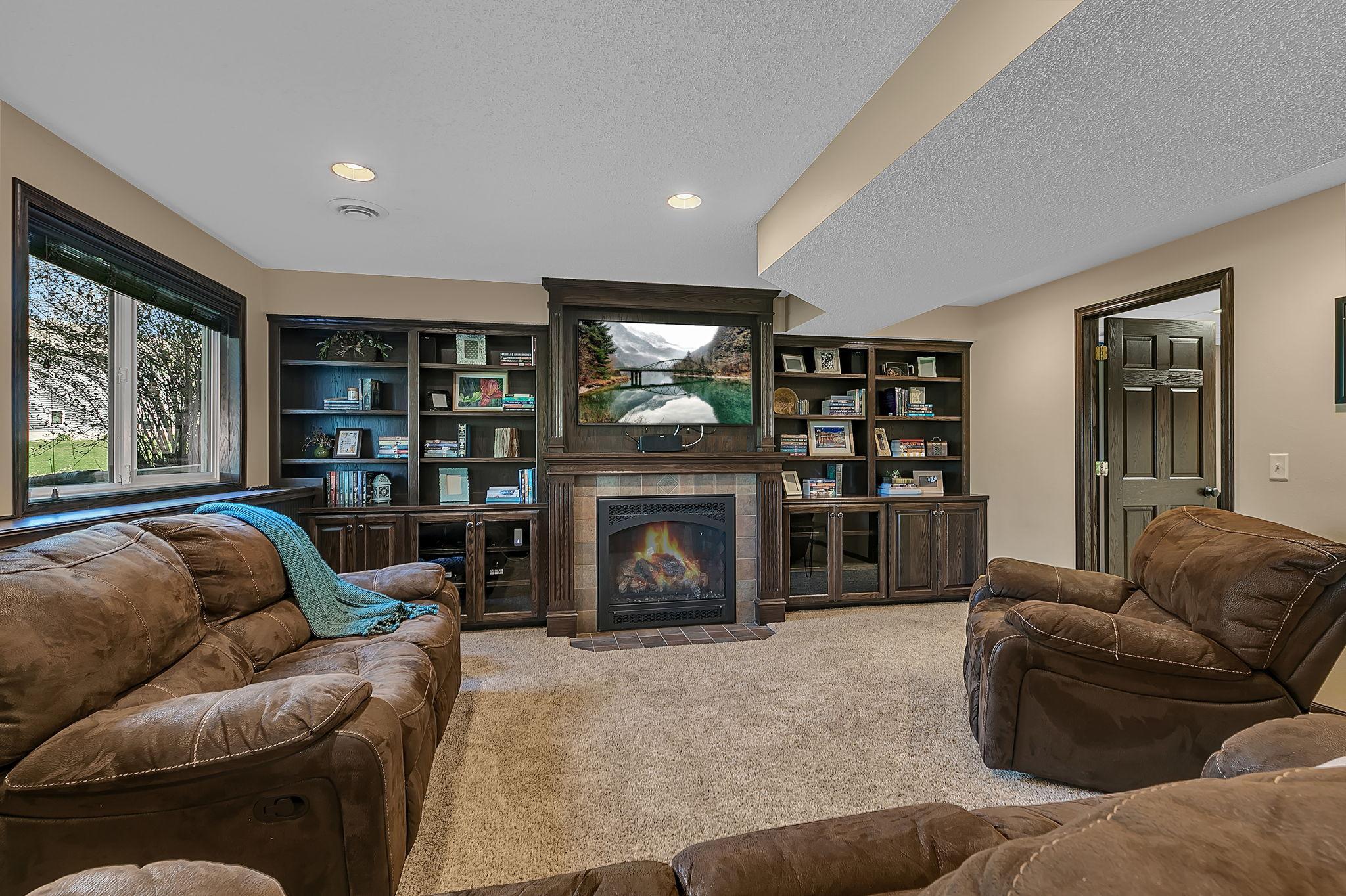 Lower level family room features gorgeous built-ins and the second gas fireplace
