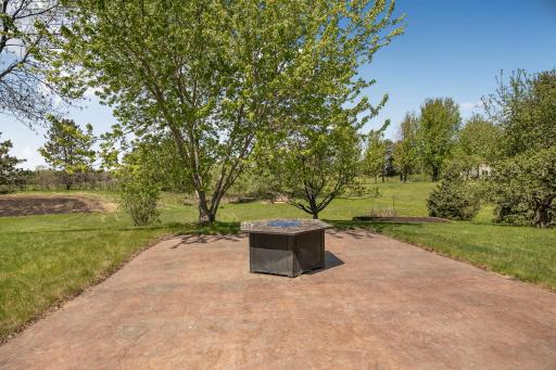 Large flat yard with stamped concrete firepit area + raised garden beds