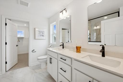 (Photo of a decorated model, actual homes finishes will vary) The primary bath includes a double vanity and a serenity shower.