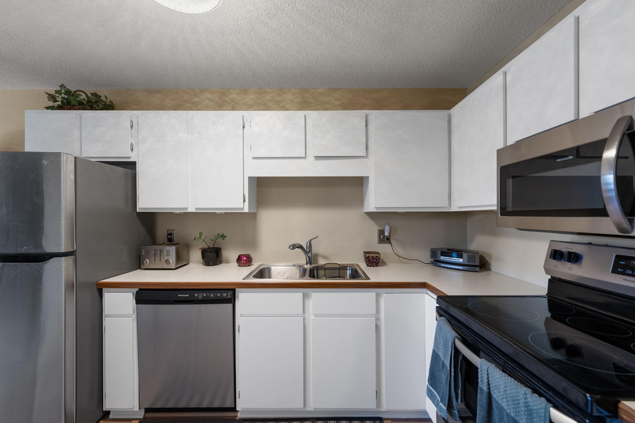 Updated kitchen with large storage cabinet to the left of this shot