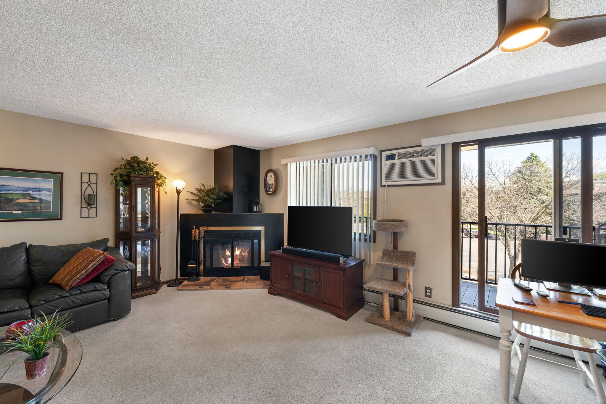 Living room anchored w/wood-burning fire place