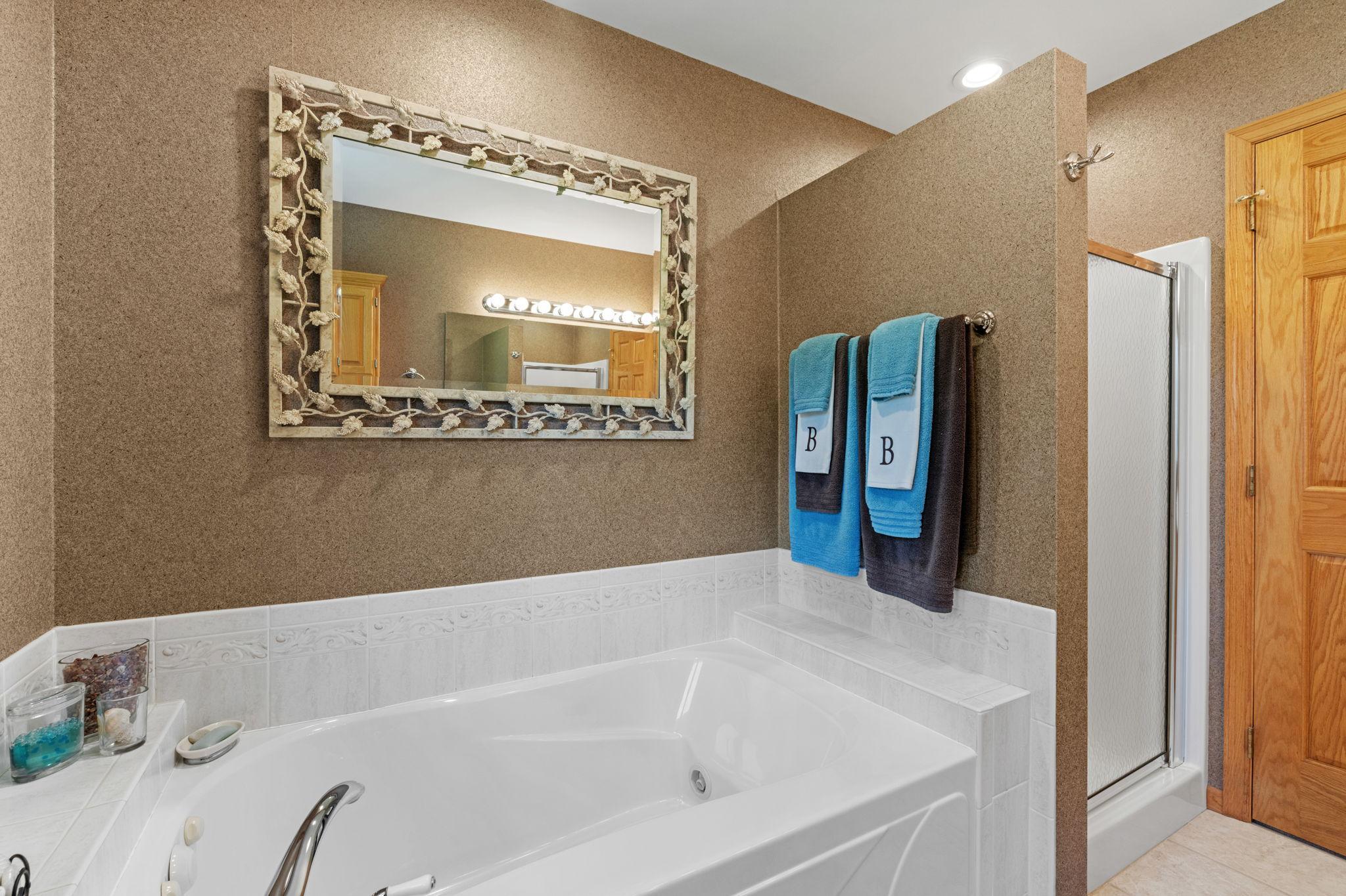 Main Floor Bathroom showing jet tub + shower