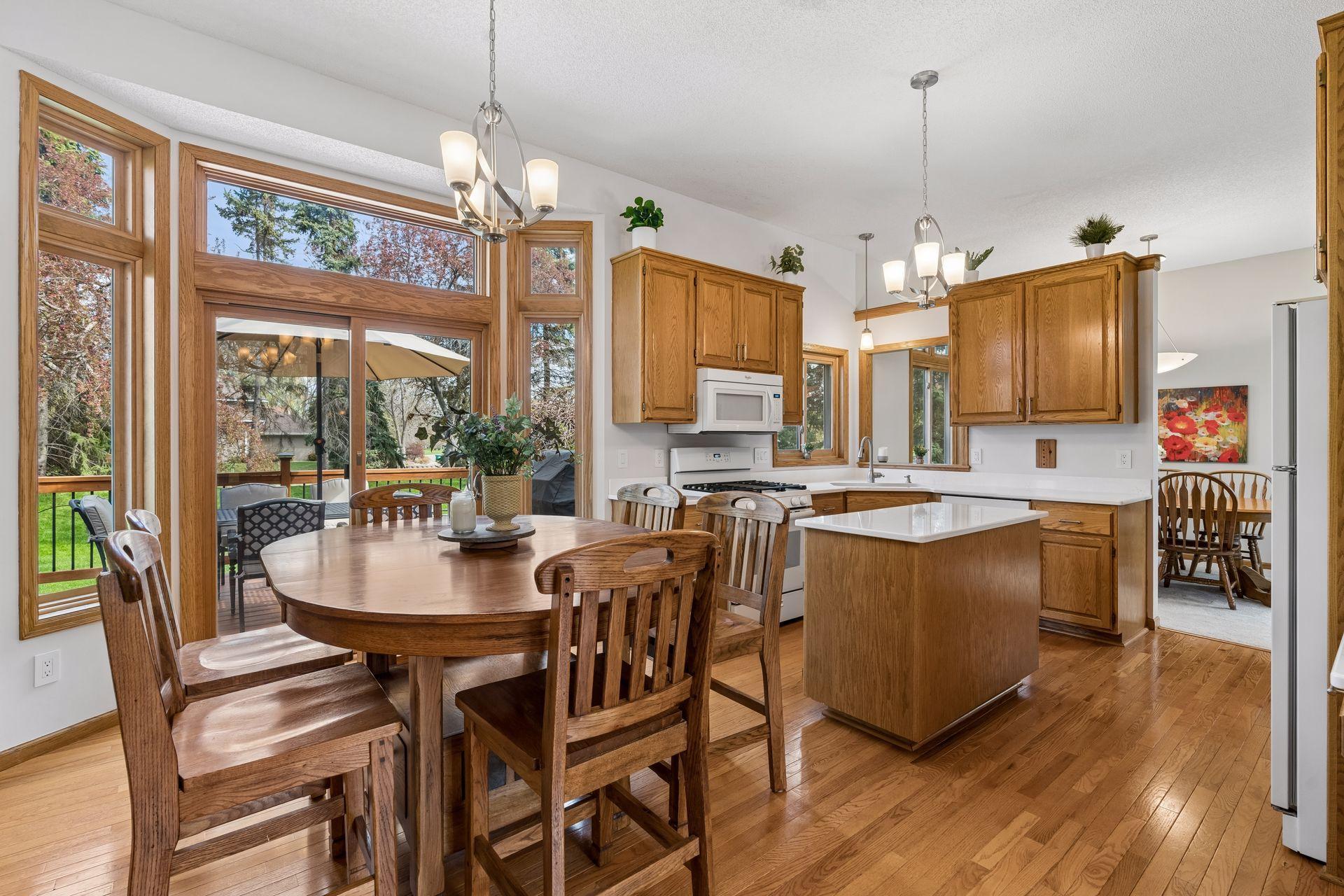 Open concept living with both formal and information dining options. This kitchen is bright and sunny, with beautiful views and easy access to the new deck and backyard. Updates including wood flooring throughout and new countertops