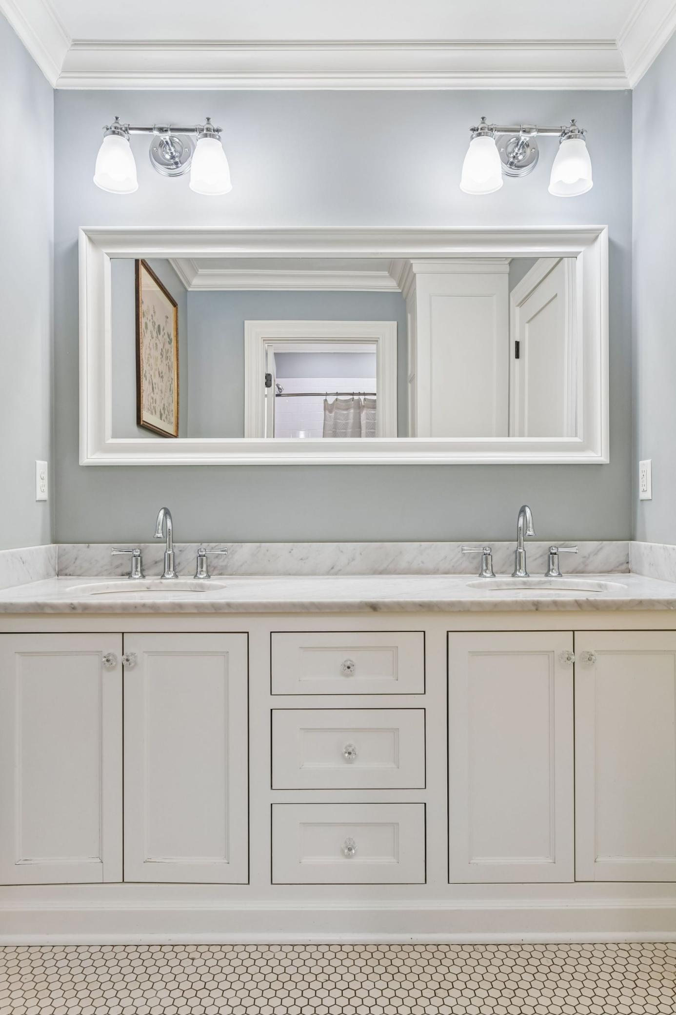 Upper level full bath. Carrera marble, inset cabinetry, hex tile.