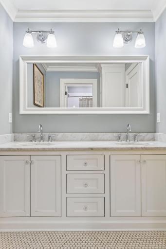Upper level full bath. Carrera marble, inset cabinetry, hex tile.
