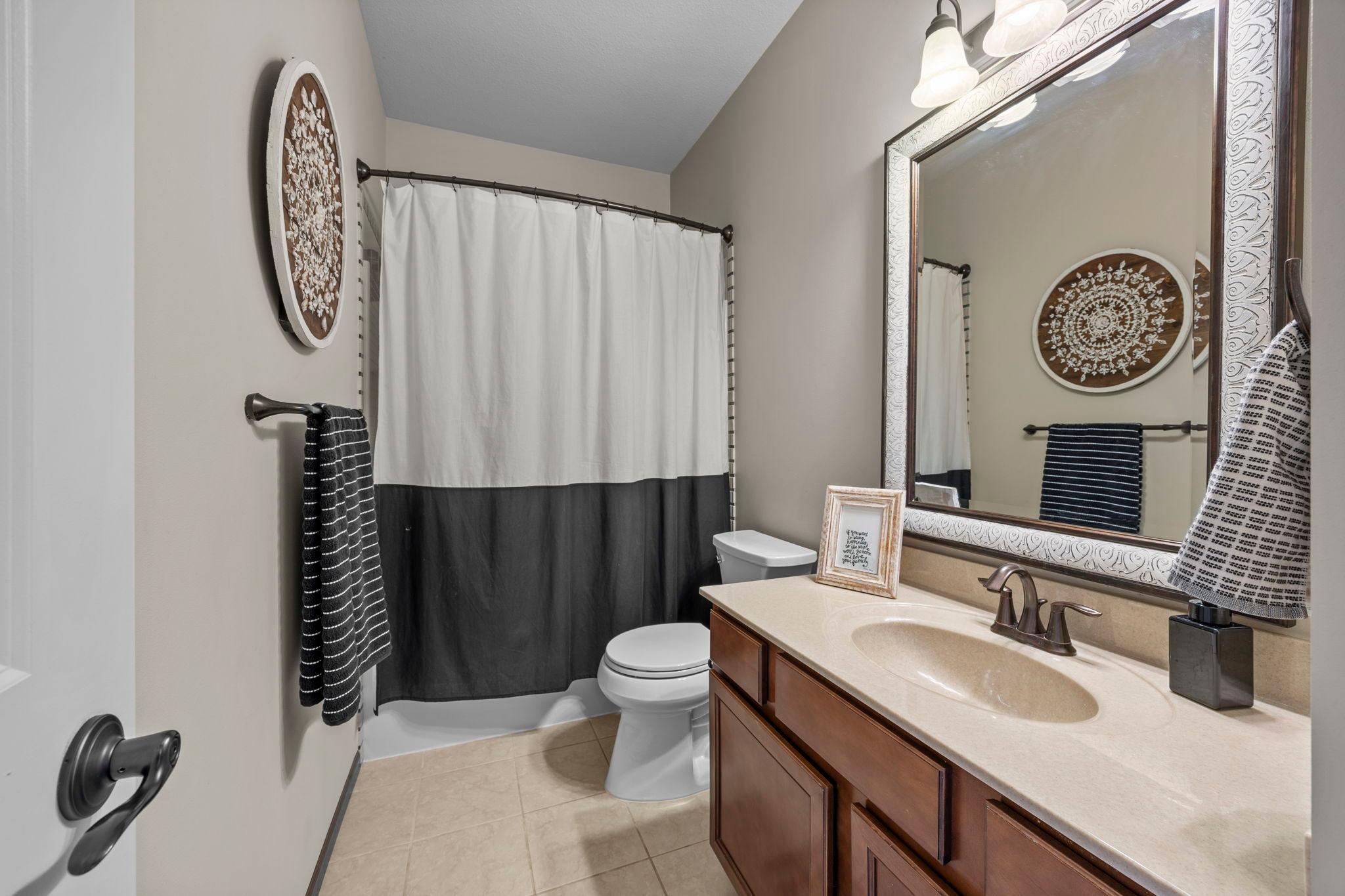 The walk-through full bathroom features a tub/shower combination and single vanity.