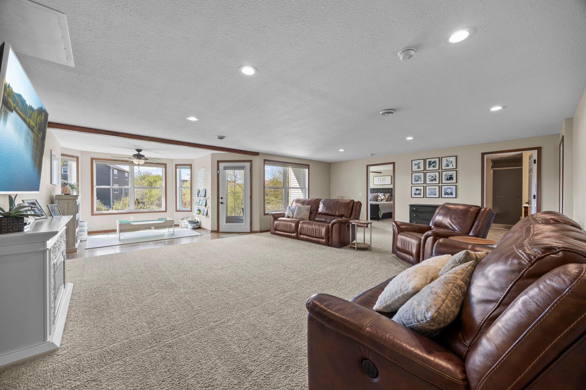 The finished lower level provides an expansive family room ideal for entertaining, with walkout access to the backyard.