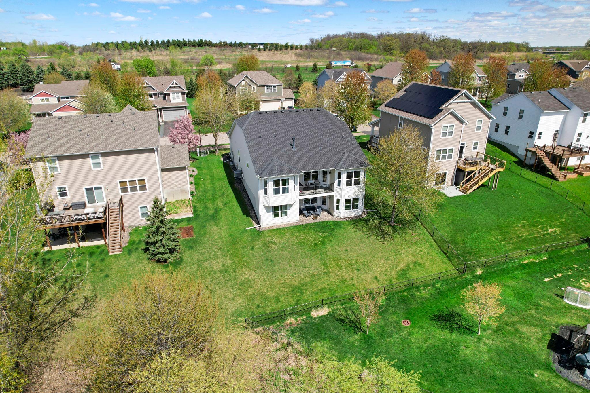 The spacious backyard offers plenty of room for outdoor activities and entertaining.