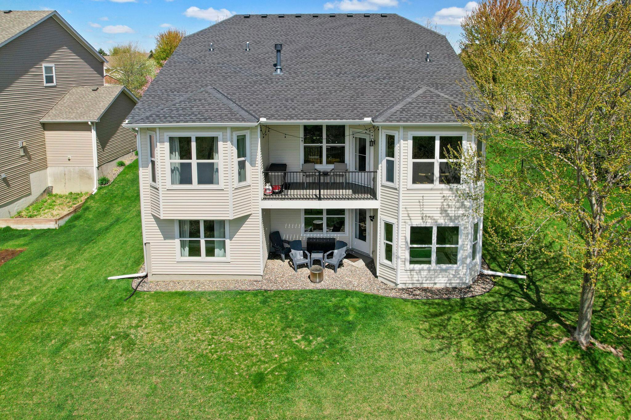 A rear exterior view of the home showcasing the covered deck and walkout space.
