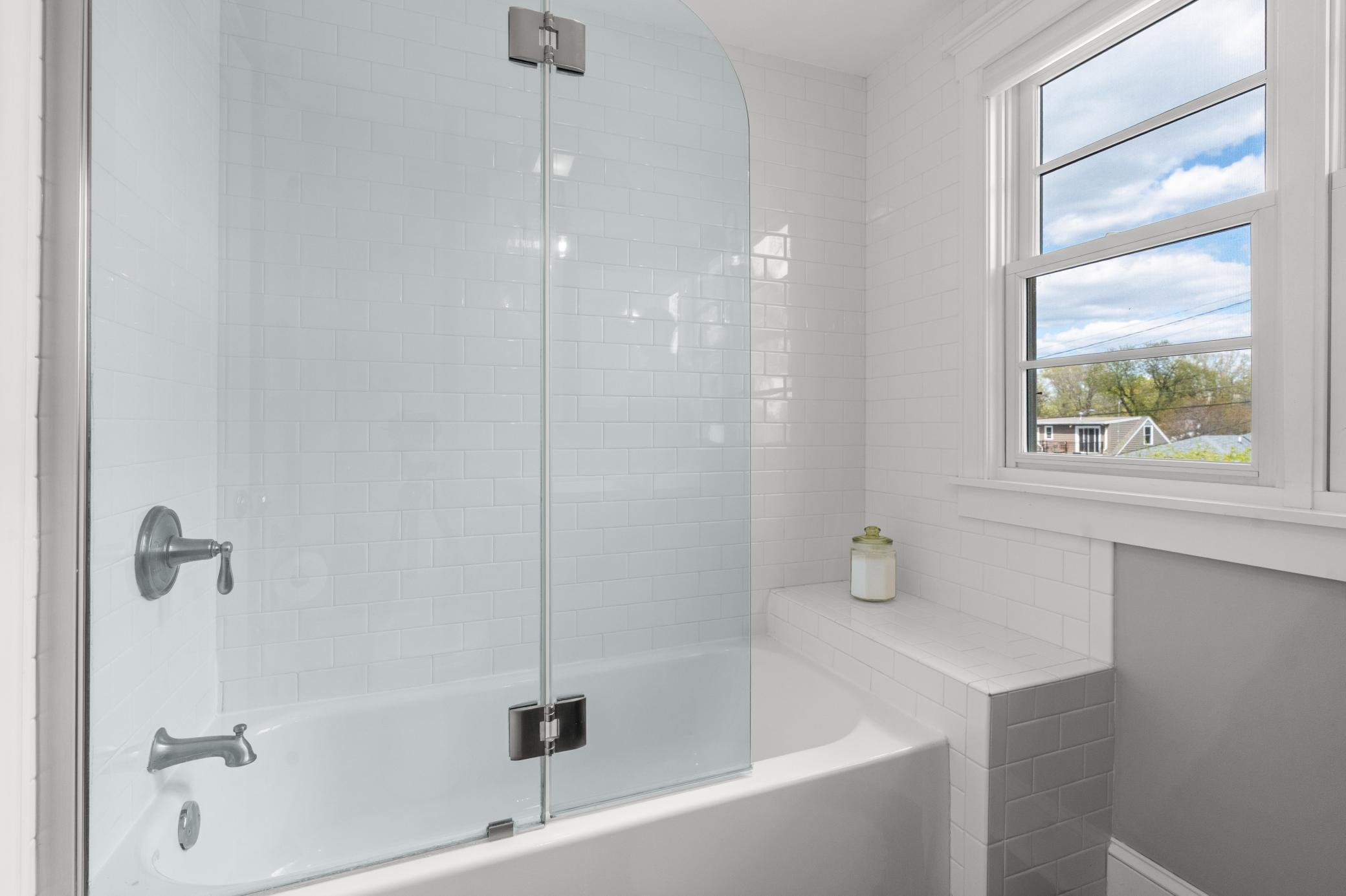 A closer look at the tub and shower combination in the shared full bathroom.