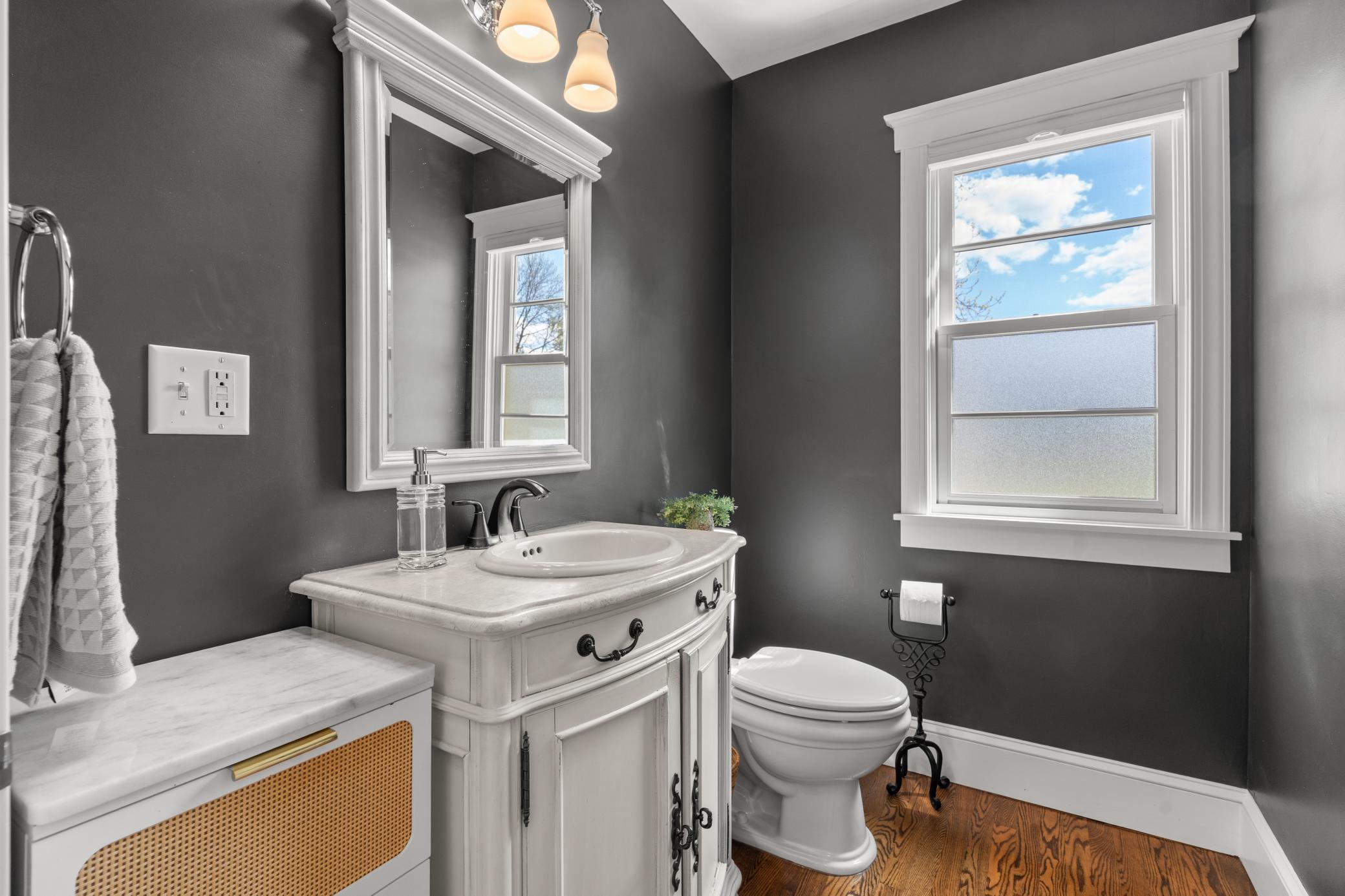 Just down the hall a convenient main-level half bath with a single vanity completes the floor.
