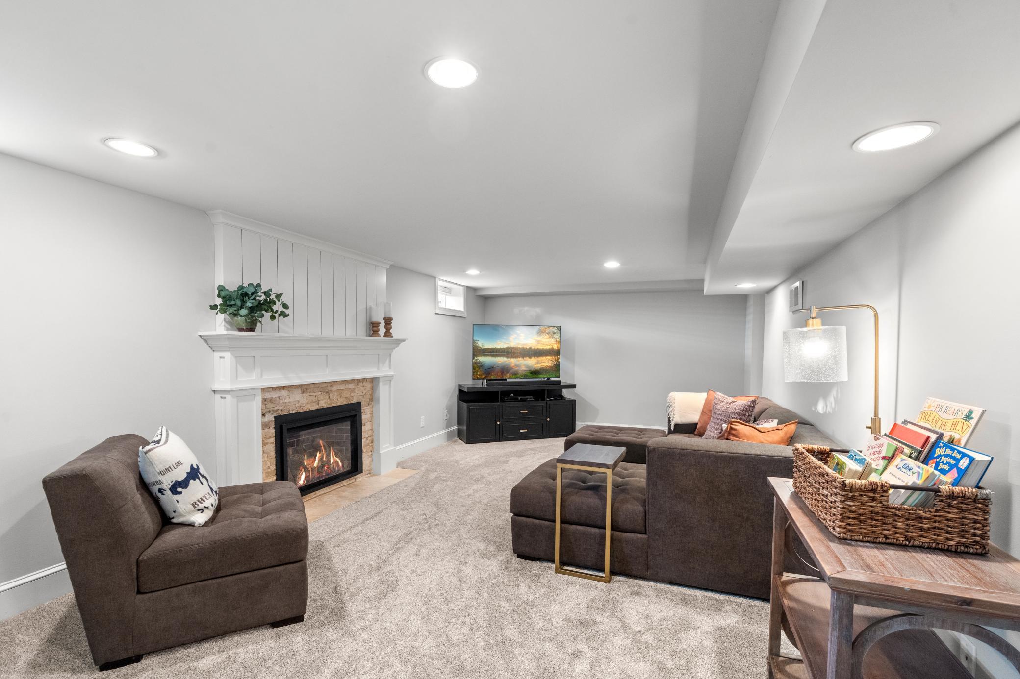 The finished lower level offers a spacious family room with carpeting and a second gas fireplace.