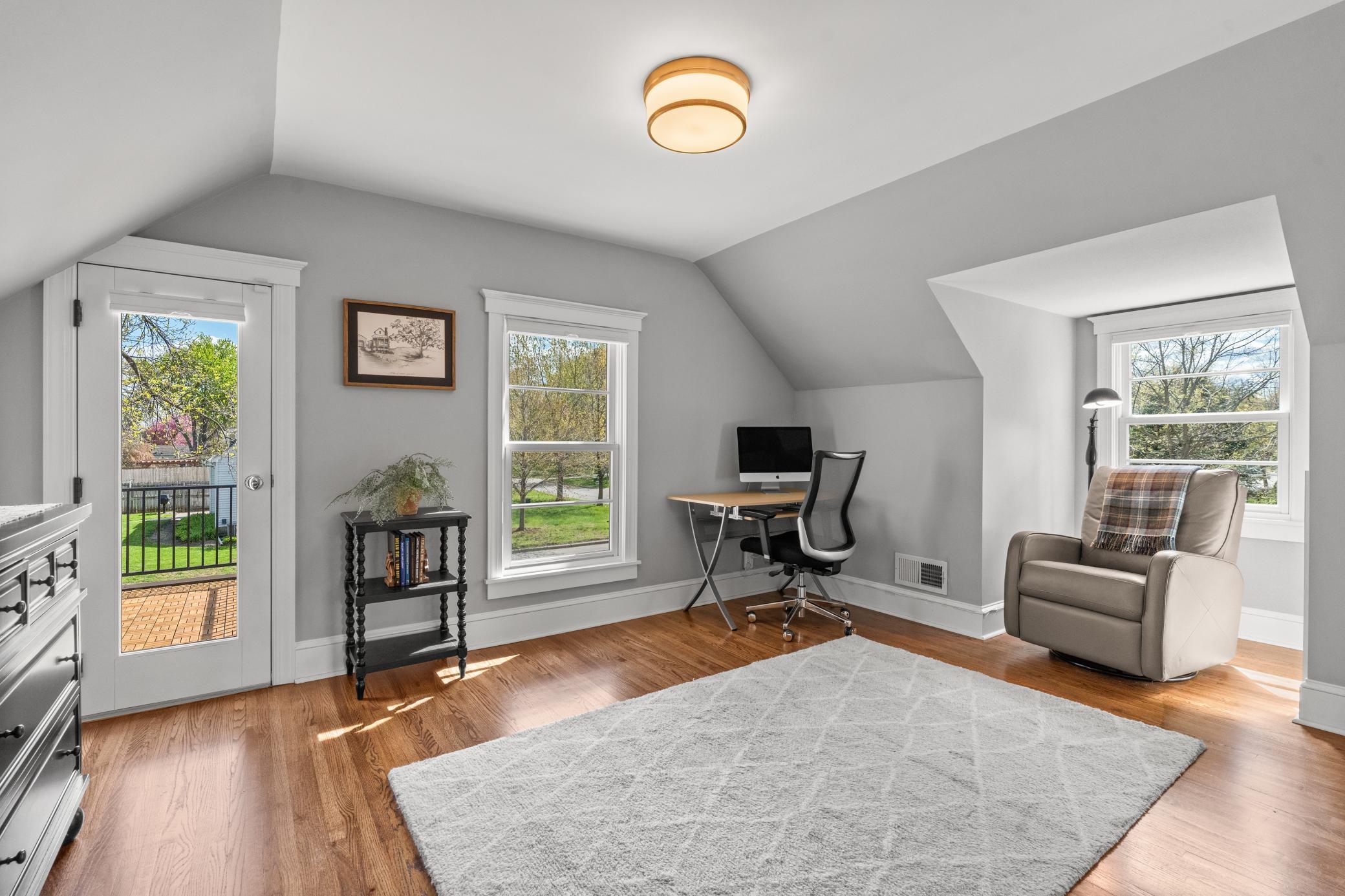 Upstairs you’ll find two bedrooms, including the primary suite with hardwood floors, a walk-in closet, and a private rooftop deck.